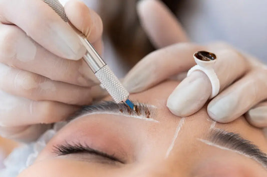 Eyebrow lamination procedure in progress, with a technician applying treatment to shaped eyebrows.