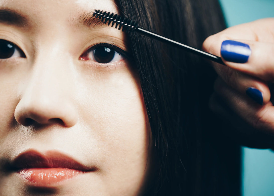 Woman brushing eyebrows