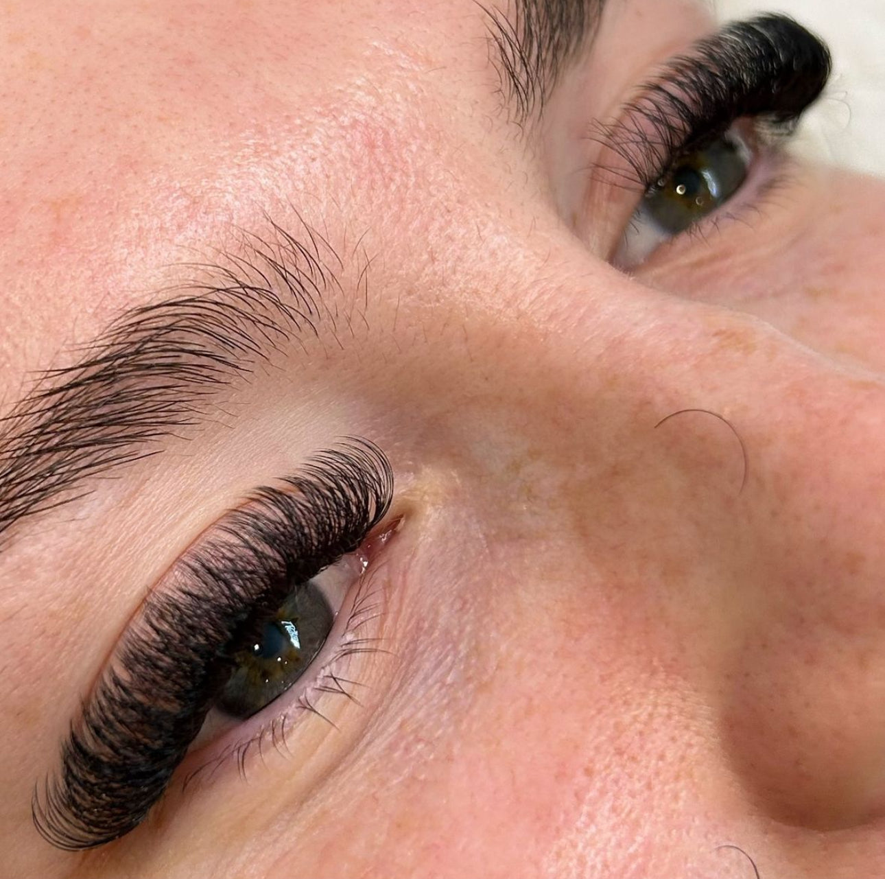 Stunning extensions accentuate a woman's naturally gorgeous eyelashes in this close-up shot. Thanks to Lash Belo Cheat Code DIY Lash Kit.