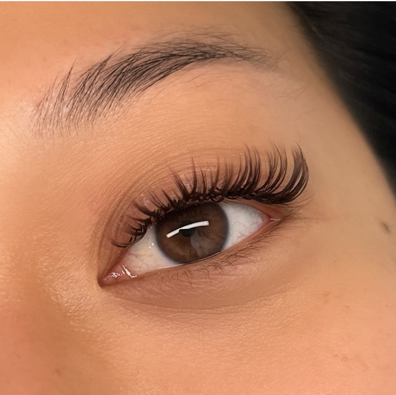 Close-up of a woman with dramatic, elegant eyelashes, enhanced by Belo Lash, showcasing their beauty and impact.